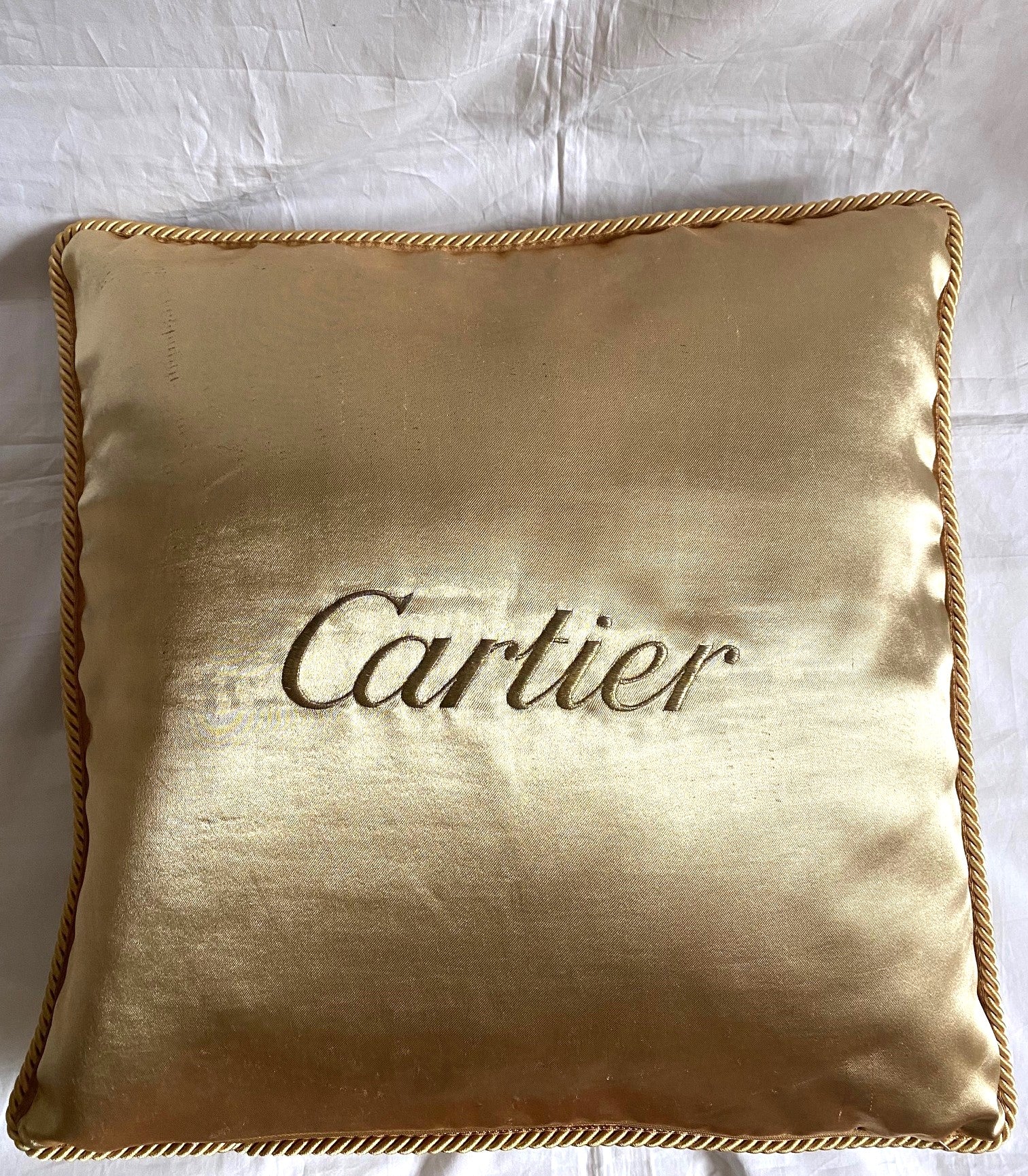 Cartier Christmas event gold satin cushion