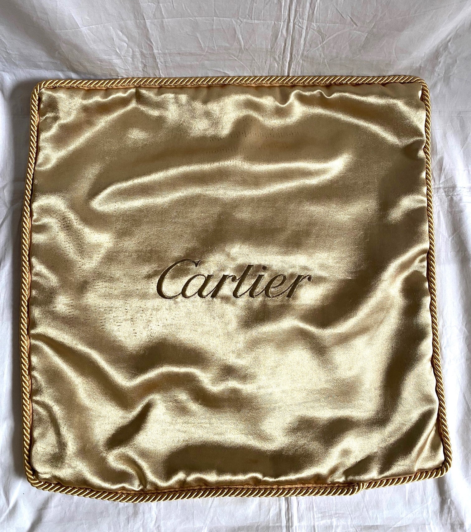 Cartier Christmas event gold satin cushion
