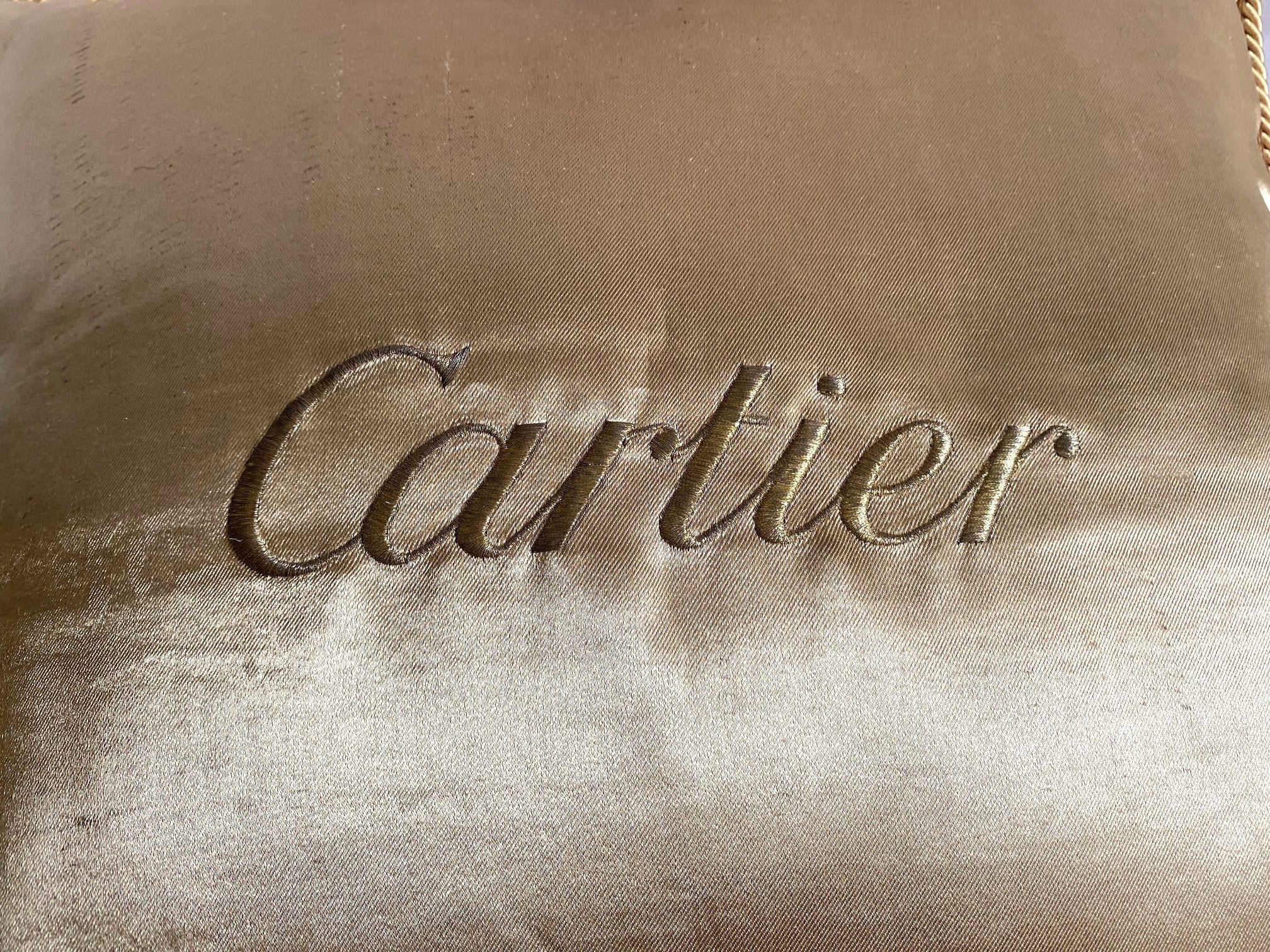 Cartier Christmas event gold satin cushion