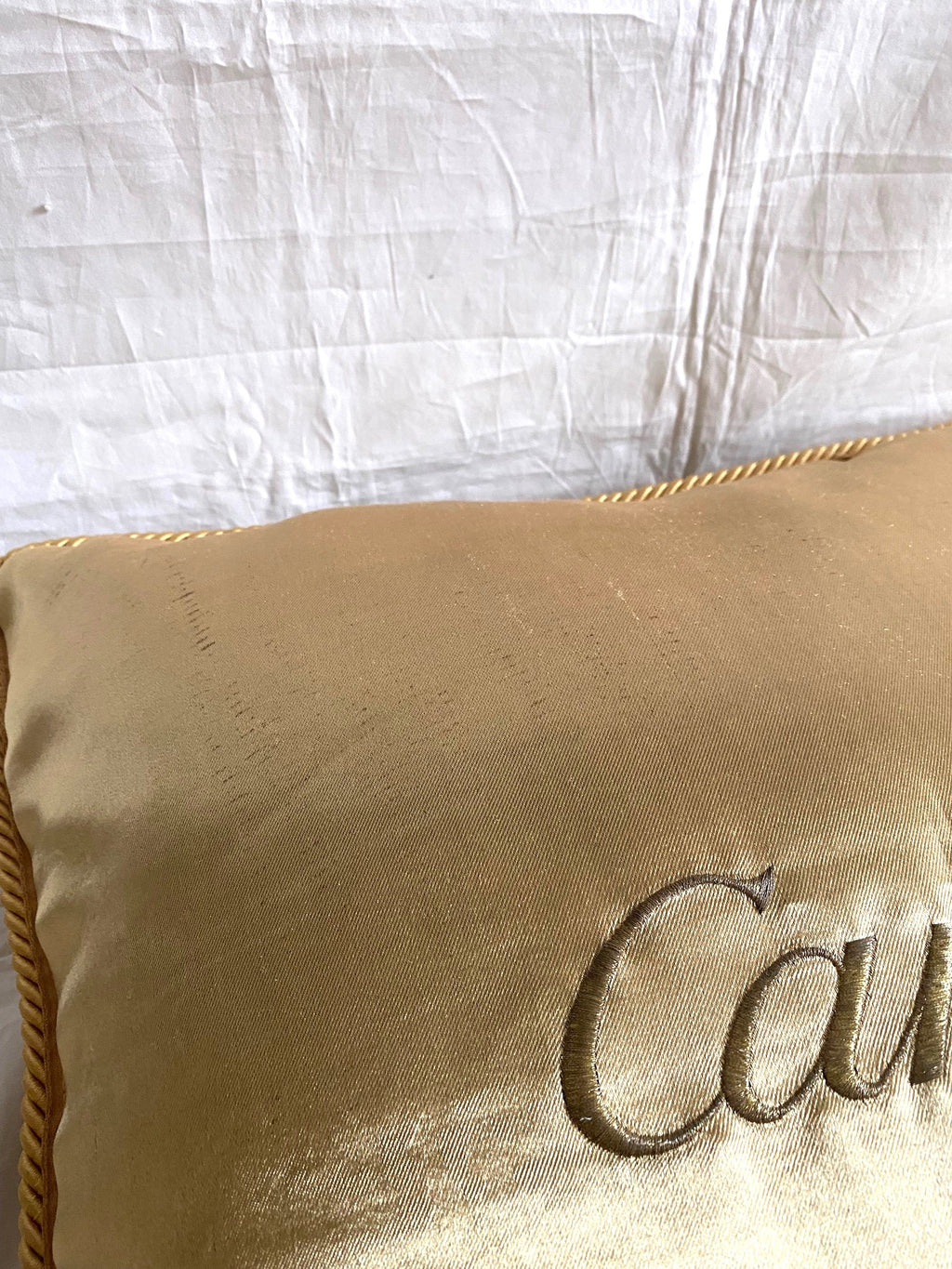 Cartier Christmas event gold satin cushion