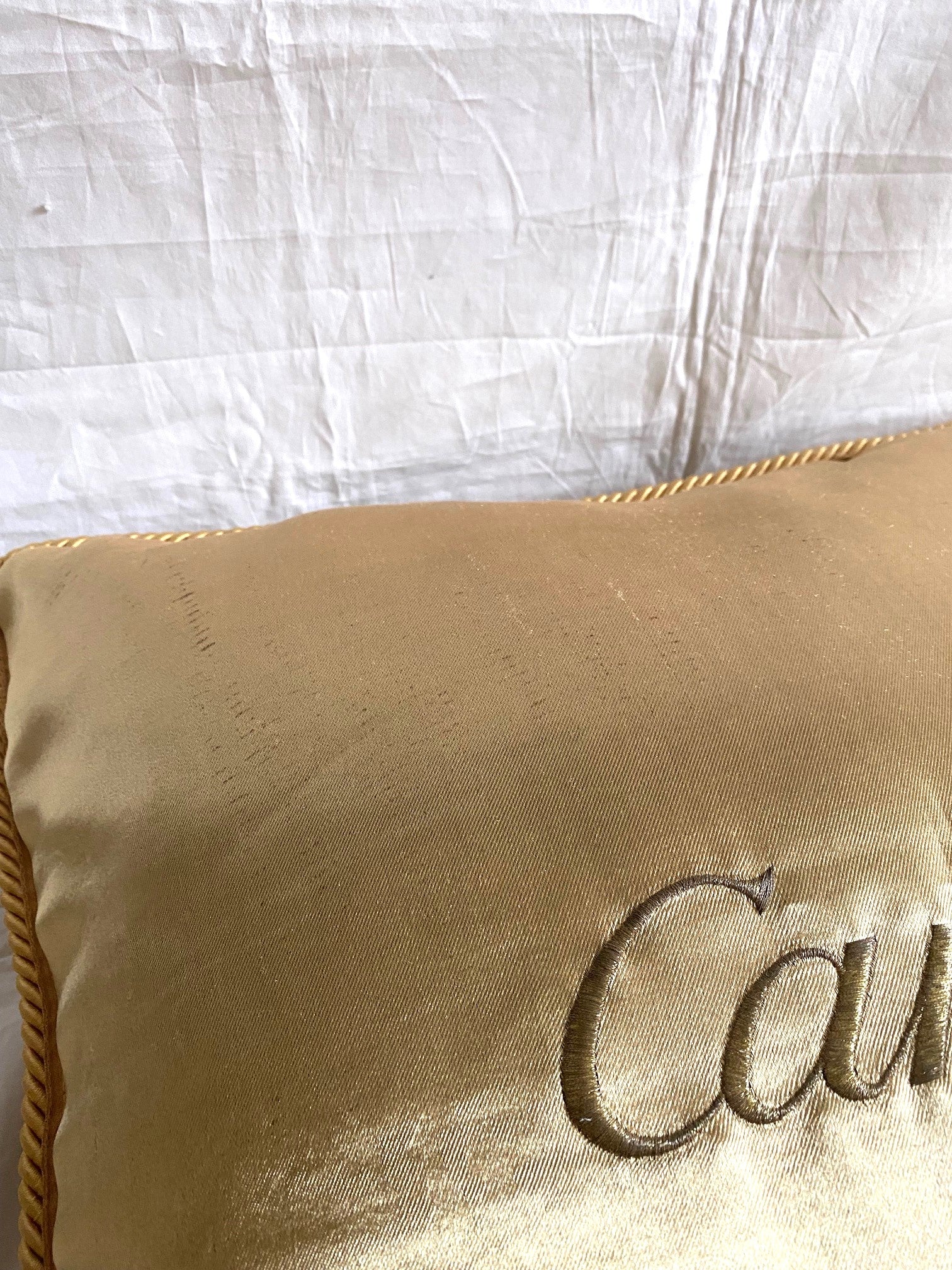 Cartier Christmas event gold satin cushion