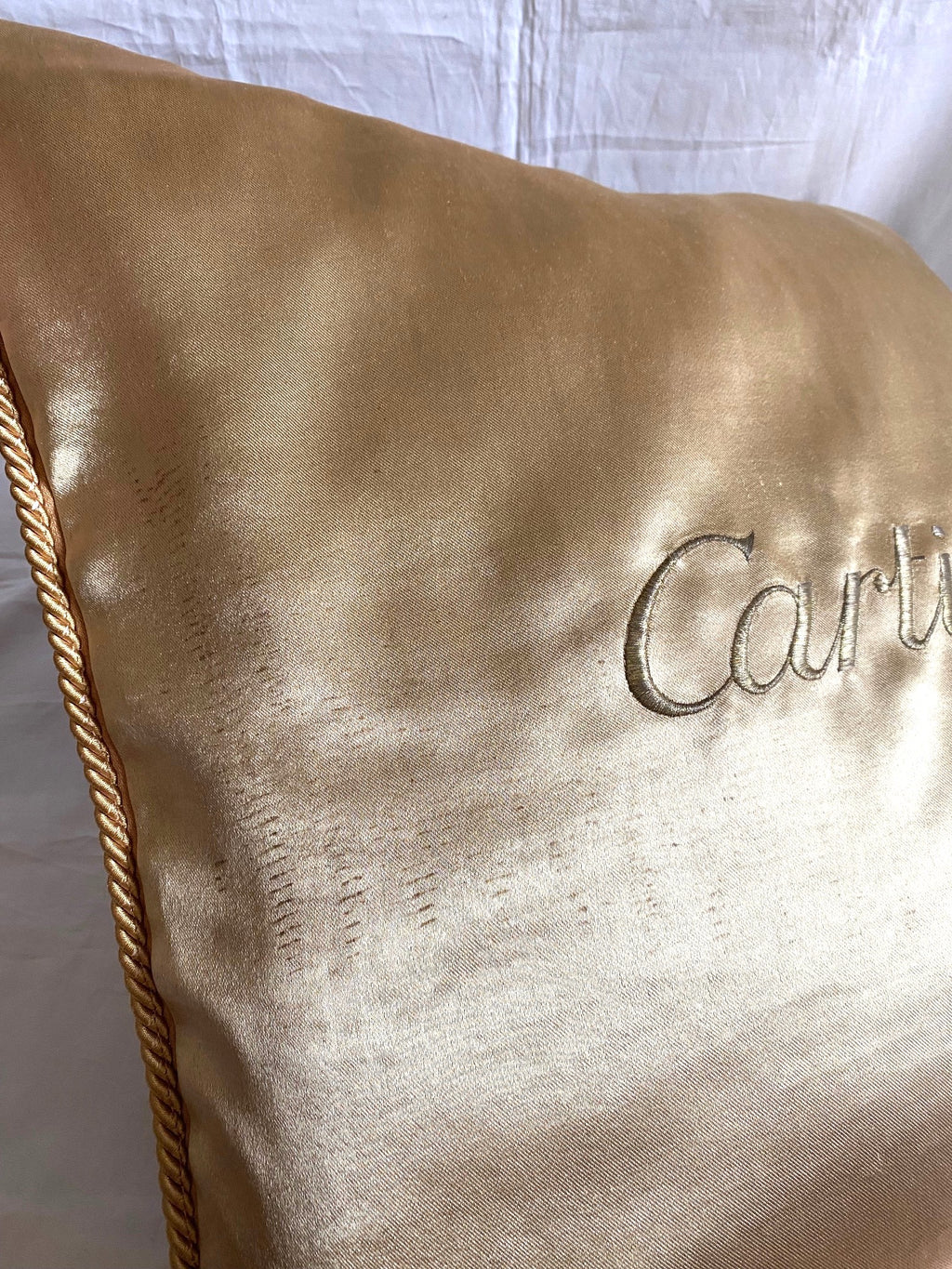 Cartier Christmas event gold satin cushion
