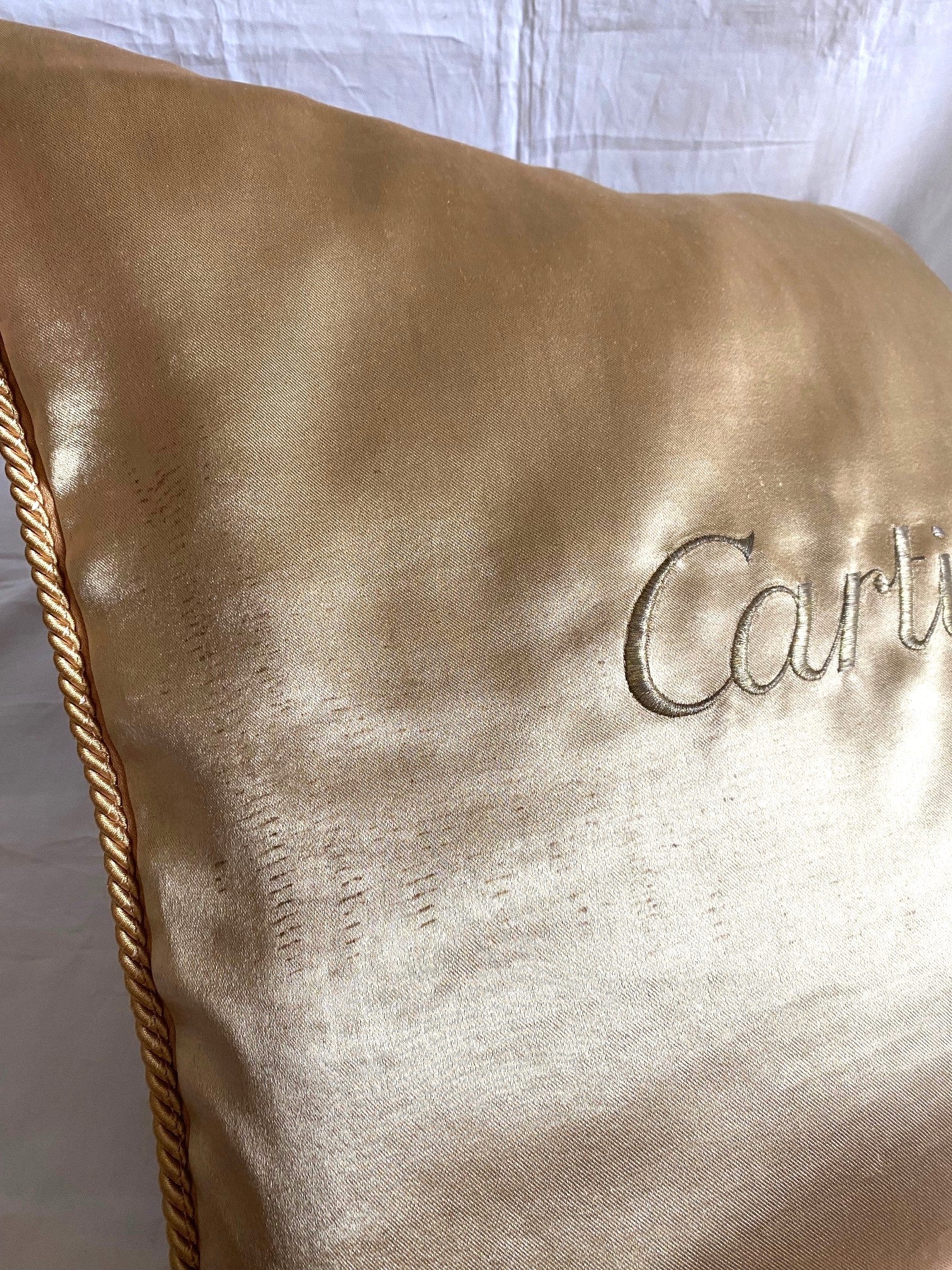 Cartier Christmas event gold satin cushion