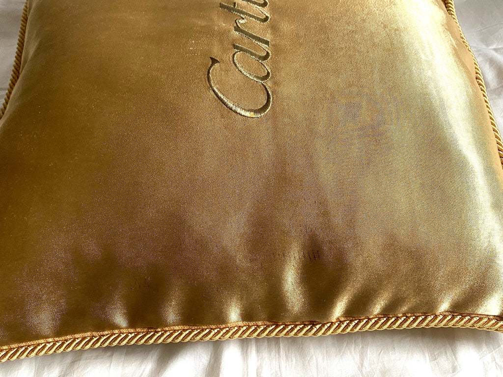 Cartier Christmas event gold satin cushion