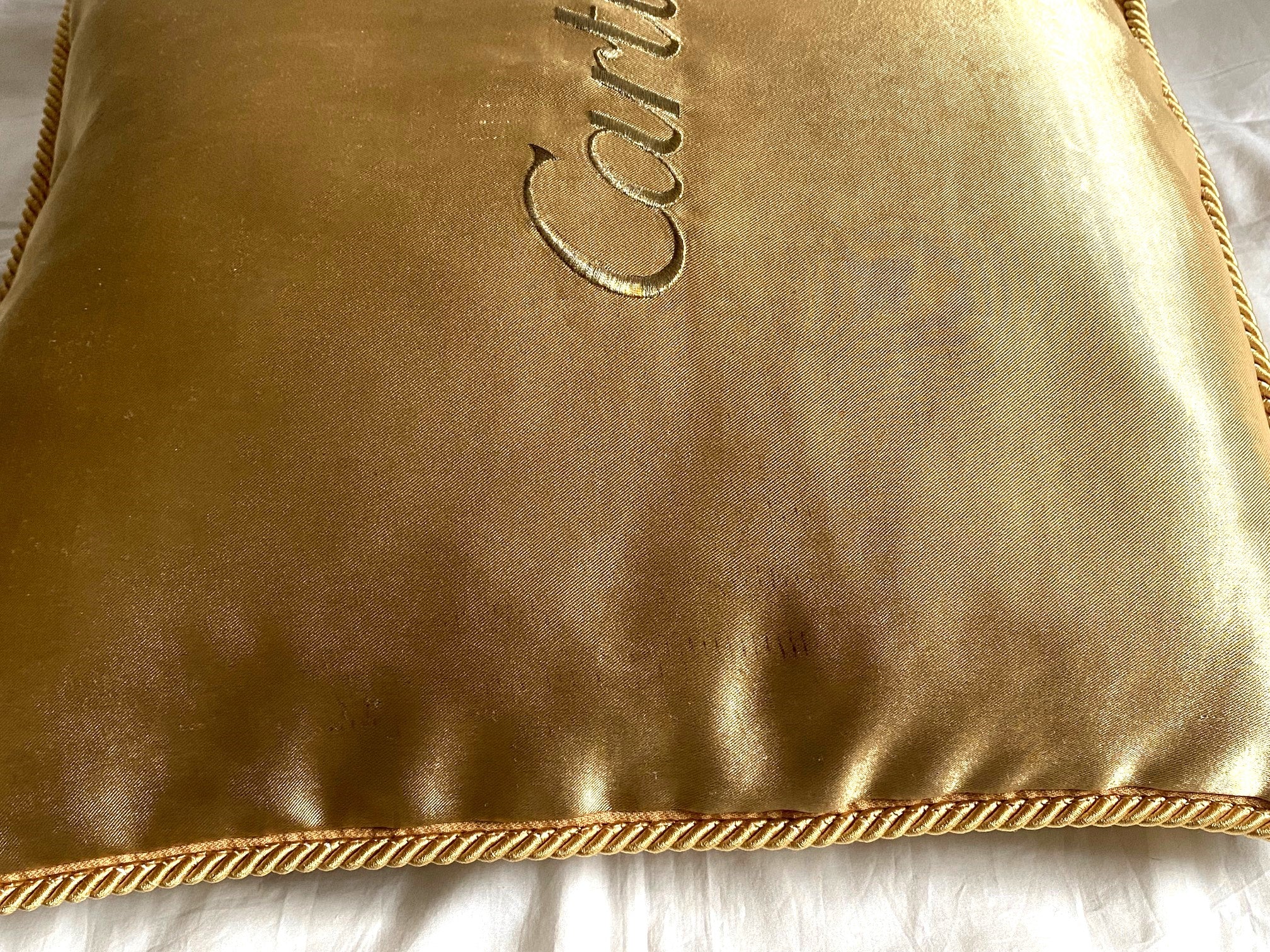 Cartier Christmas event gold satin cushion