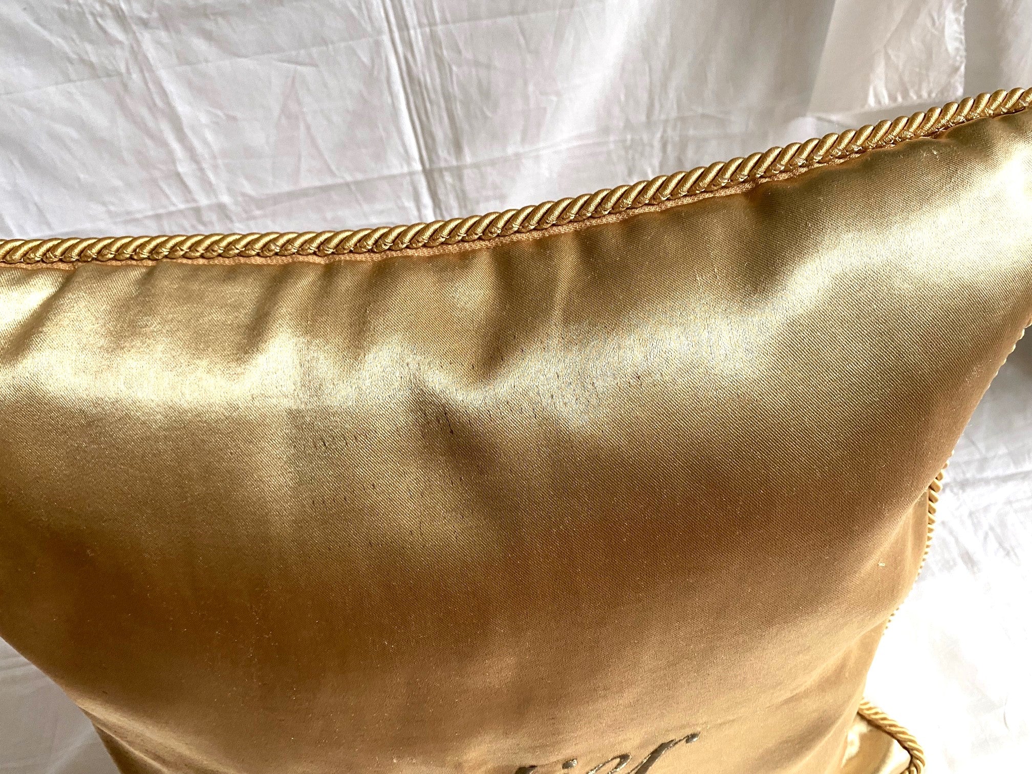 Cartier Christmas event gold satin cushion