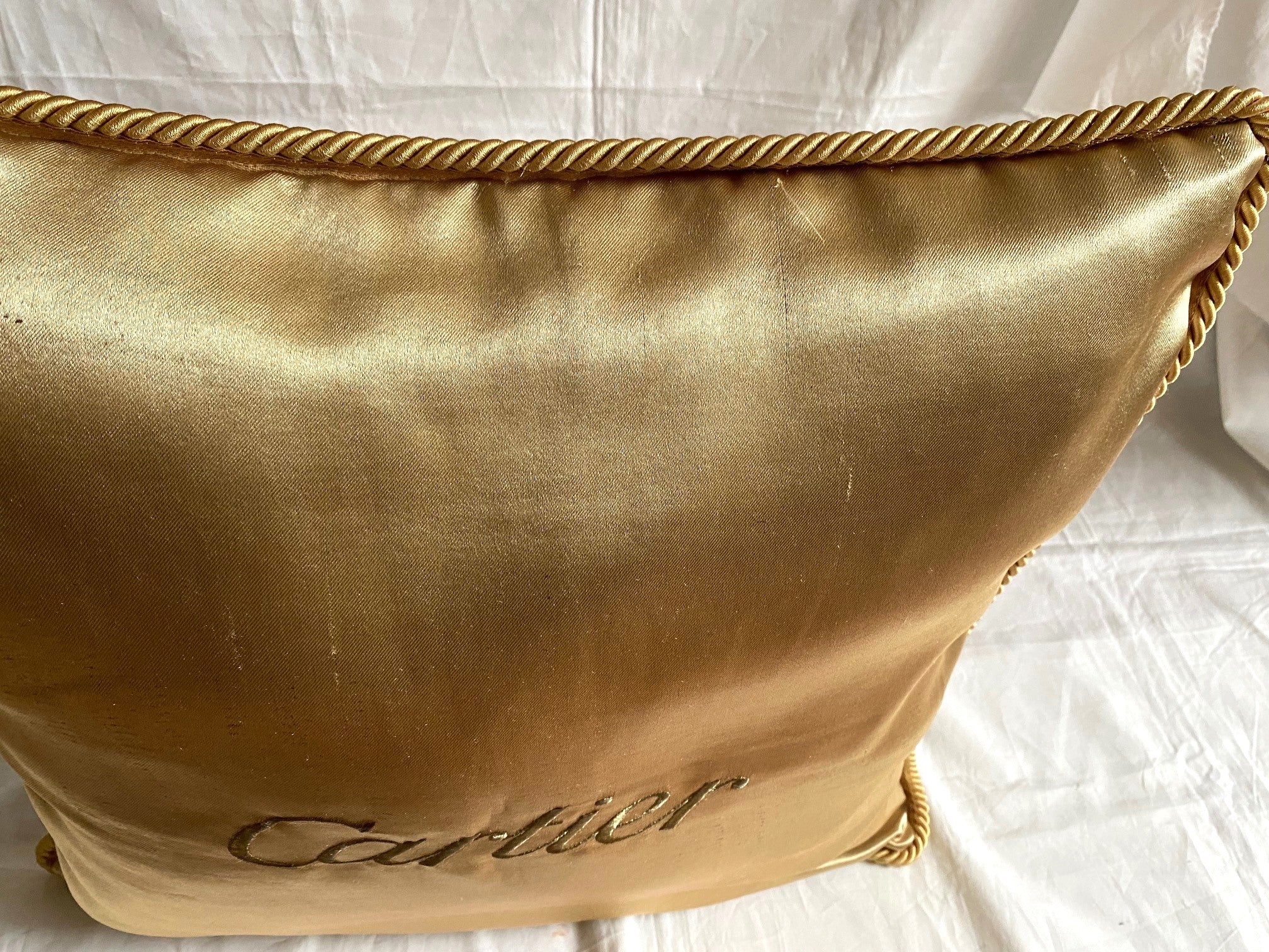 Cartier Christmas event gold satin cushion