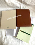 Rolex notebook with leather case & Caran d’Ache pen