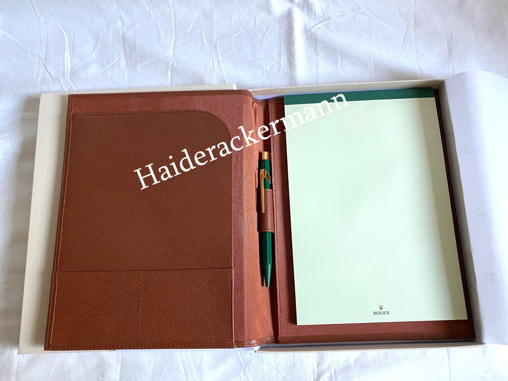Rolex notebook with leather case & Caran d’Ache pen